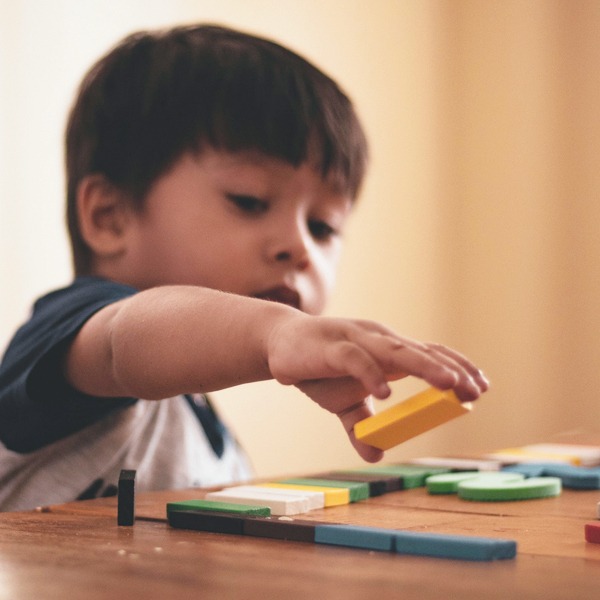 Young boy playing with blocks during Play Therapy
